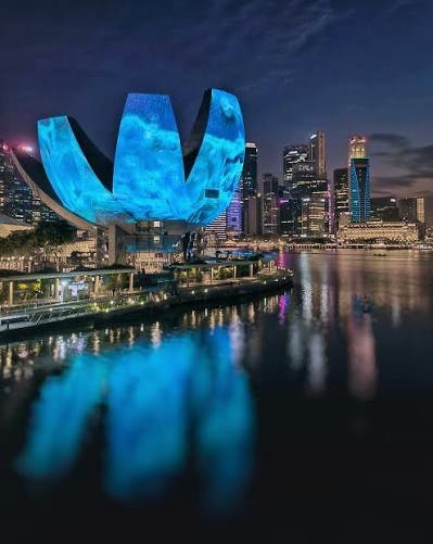 The ArtScience Museum and Marina Bay skyline lit up at night in Singapore